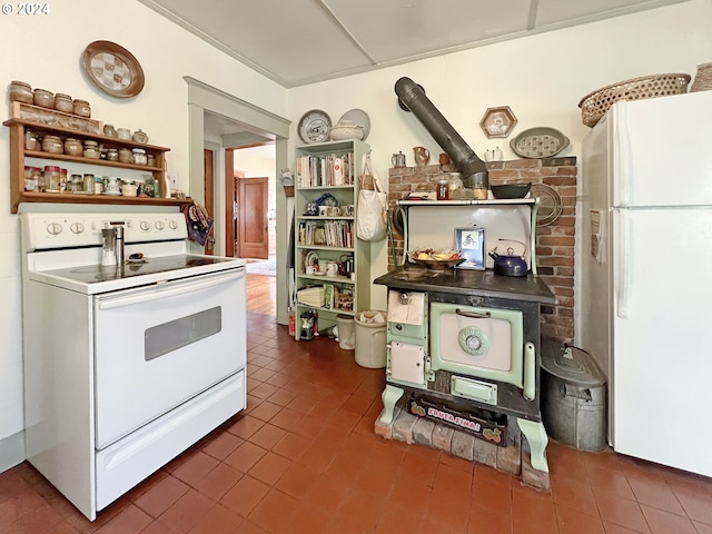 kitchen with dark tile patterned floors and white appliances