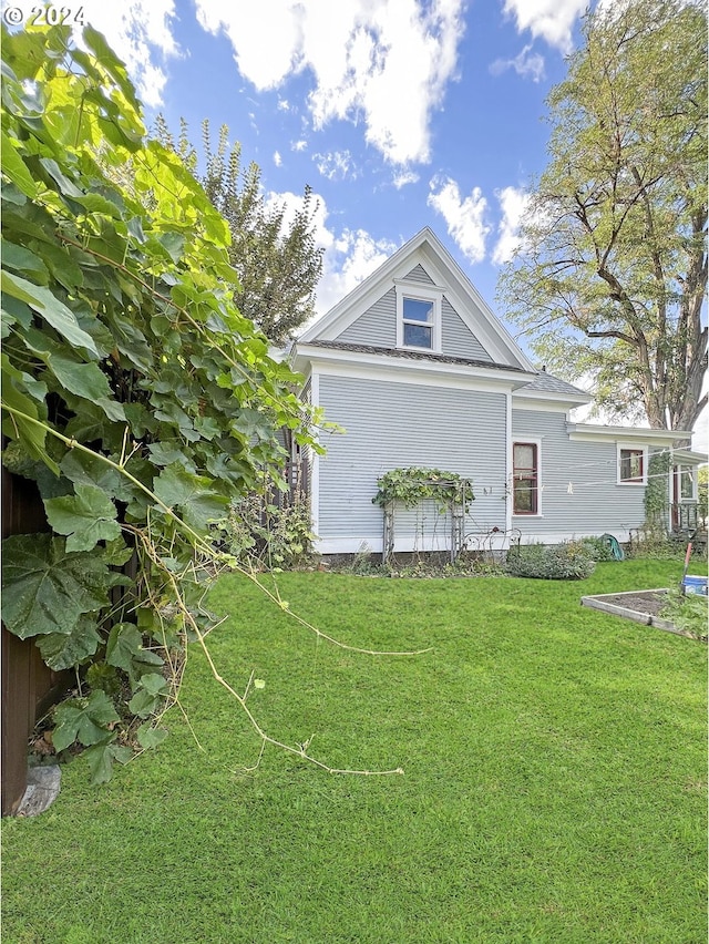 view of side of property with a yard