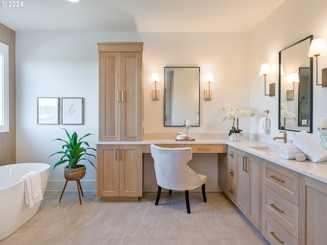 bathroom featuring a washtub and vanity