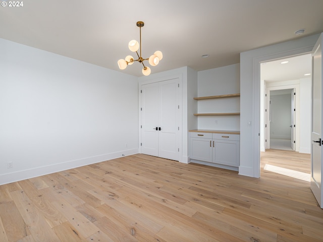 interior space featuring a chandelier and light hardwood / wood-style floors