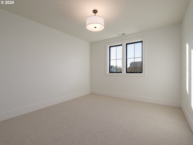 unfurnished room featuring carpet