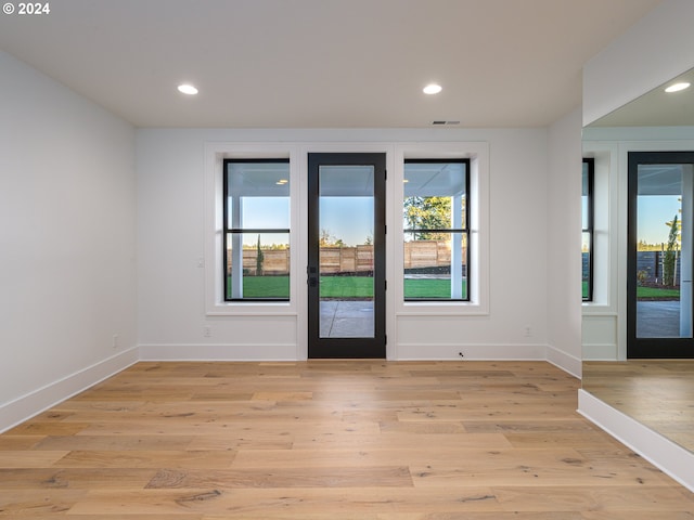 interior space with french doors and light hardwood / wood-style floors