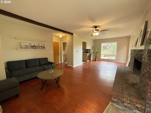 living room featuring hardwood / wood-style flooring, ceiling fan, and a brick fireplace