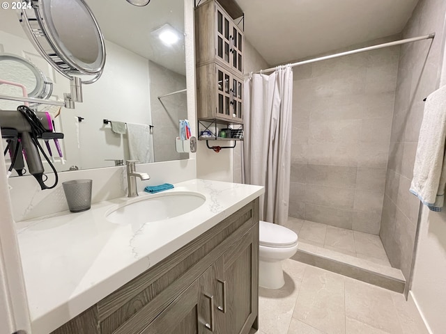 bathroom featuring vanity, toilet, a shower with shower curtain, and tile patterned floors