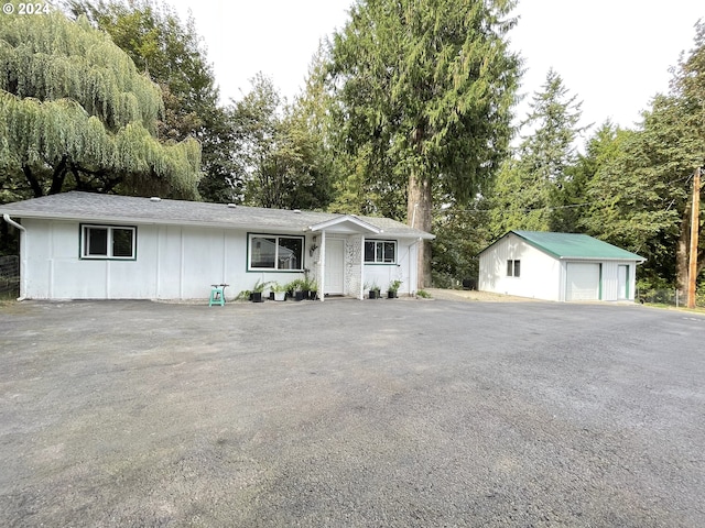 single story home with an outbuilding and a garage