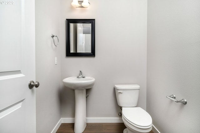 1643 NE Josephine Ct Unit 175, Estacada, OR 97023 - bathroom with toilet, baseboards, wood finished floors, and a sink