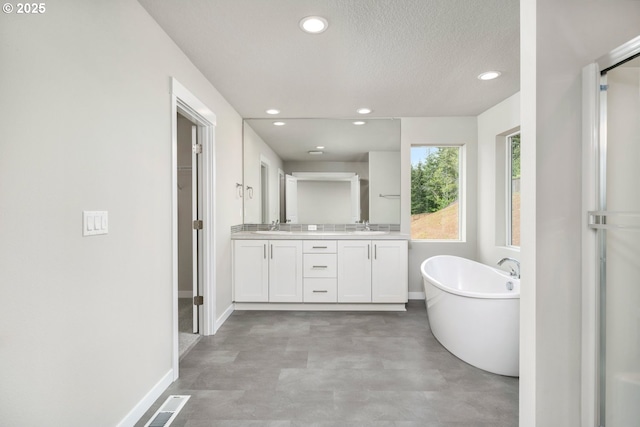 1643 NE Josephine Ct Unit 175, Estacada, OR 97023 - full bathroom featuring double vanity, recessed lighting, a soaking tub, baseboards, and a walk in closet