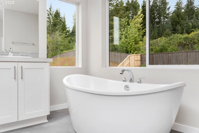 1643 NE Josephine Ct Unit 175, Estacada, OR 97023 - bathroom featuring a freestanding bath, baseboards, and vanity
