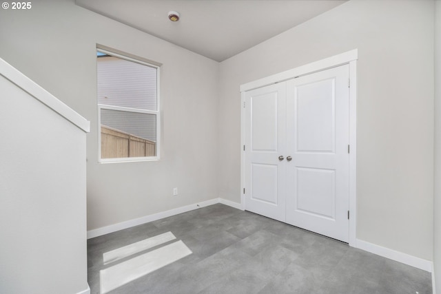 1643 NE Josephine Ct Unit 175, Estacada, OR 97023 - unfurnished bedroom with concrete flooring, baseboards, and a closet
