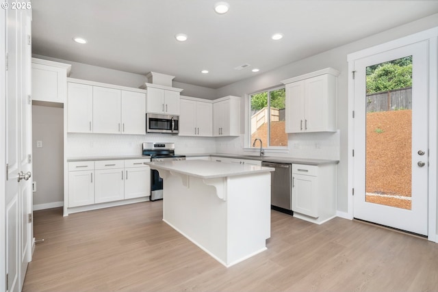 1643 NE Josephine Ct Unit 175, Estacada, OR 97023 - kitchen with stainless steel appliances, light countertops, light wood-type flooring, a kitchen island, and recessed lighting