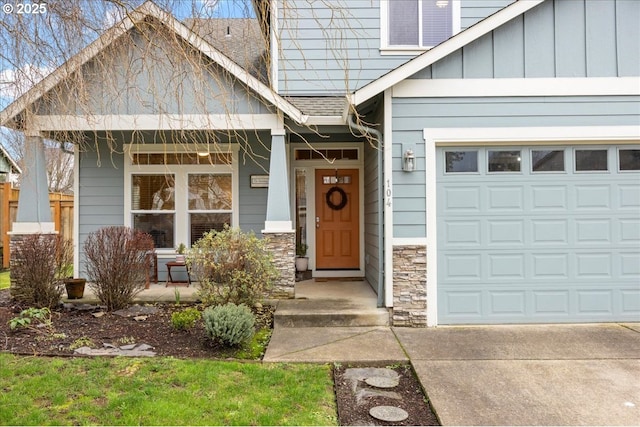 doorway to property with covered porch and a garage