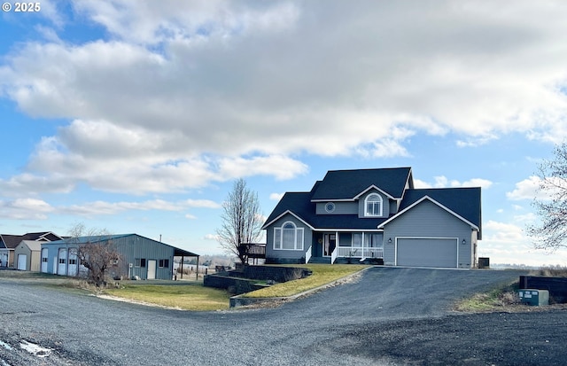 view of front of house featuring a porch, a carport, a front lawn, and a garage