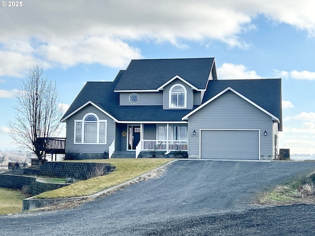 view of front of home with a garage, a porch, and cooling unit