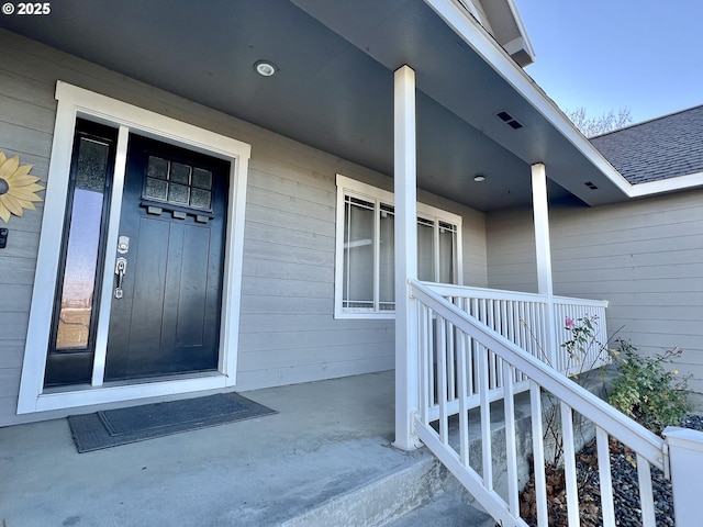 doorway to property featuring covered porch