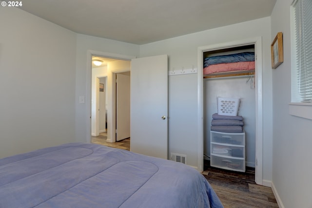 bedroom with hardwood / wood-style floors and a closet