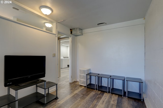 living room featuring dark hardwood / wood-style flooring and washing machine and dryer