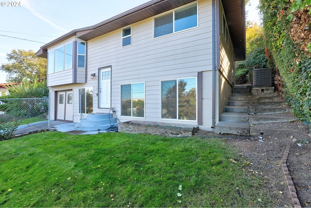 rear view of house featuring a yard