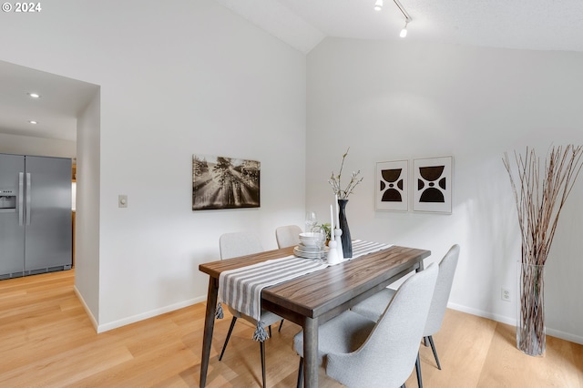 kitchen with tasteful backsplash, light hardwood / wood-style flooring, stainless steel appliances, and track lighting