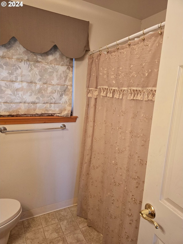 bathroom with tile patterned flooring and toilet