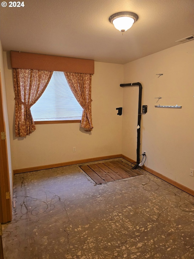 empty room with a textured ceiling