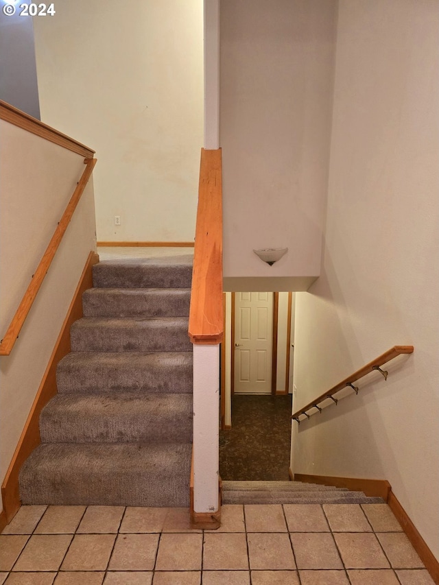 stairway with tile patterned floors