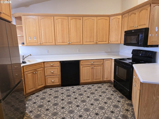 kitchen with sink, vaulted ceiling, and black appliances