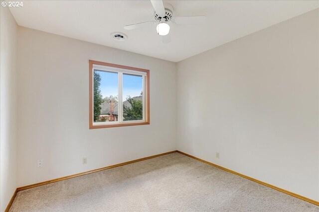 empty room with carpet floors and ceiling fan