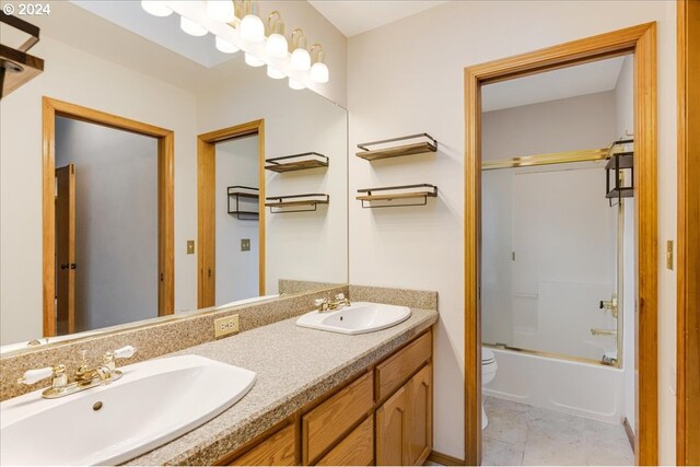 full bathroom with shower / bath combination with glass door, vanity, toilet, and tile patterned flooring