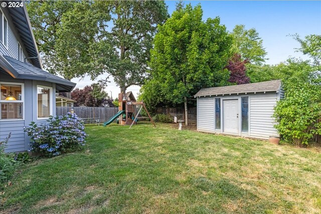 view of yard with a shed and a playground