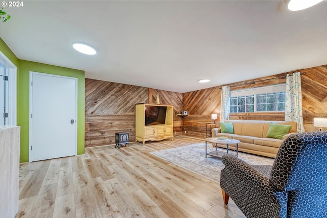 living room featuring wood walls and light hardwood / wood-style flooring