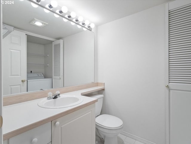 bathroom with vanity, toilet, and washer / clothes dryer