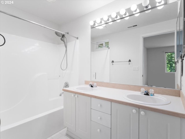 bathroom with vanity and shower / washtub combination