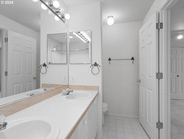 bathroom featuring toilet and vanity