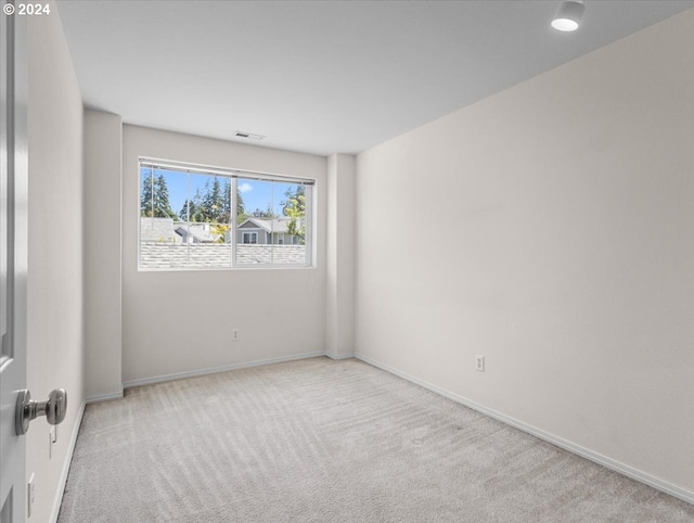 unfurnished room featuring light colored carpet