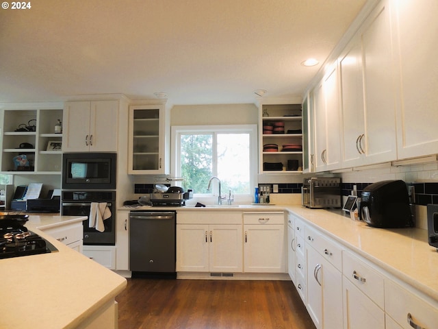 kitchen with black appliances, sink, backsplash, dark hardwood / wood-style flooring, and white cabinets