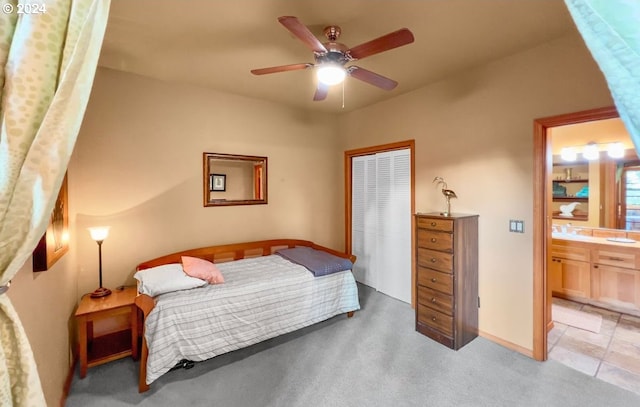 carpeted bedroom featuring ensuite bathroom and ceiling fan