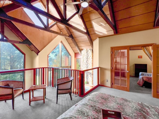 living area with beam ceiling and light carpet