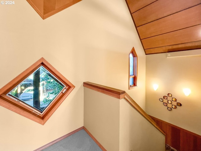 stairs featuring carpet flooring, lofted ceiling, and wood ceiling