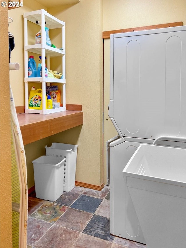 washroom featuring stacked washer / dryer