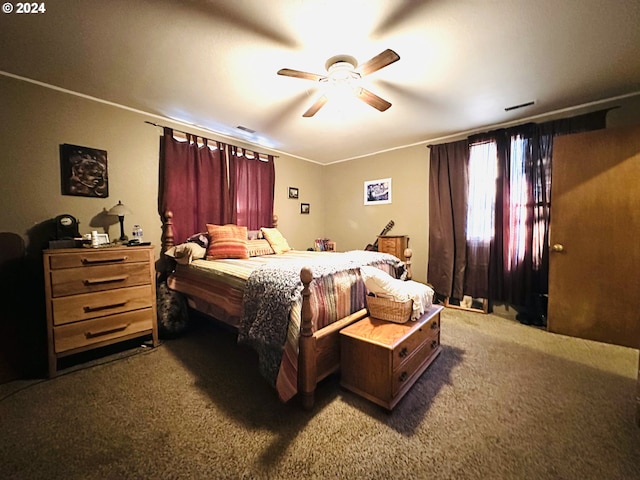 bedroom with ceiling fan and dark carpet