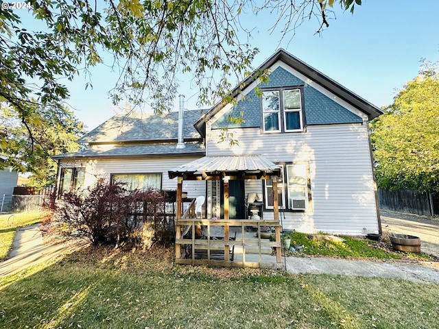 back of house featuring a lawn and cooling unit