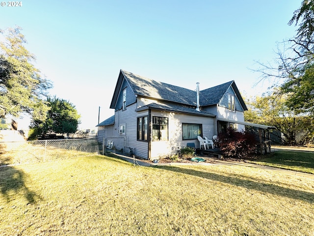 view of side of home with a yard