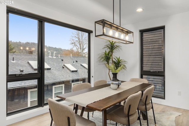 dining space featuring a notable chandelier and light hardwood / wood-style flooring