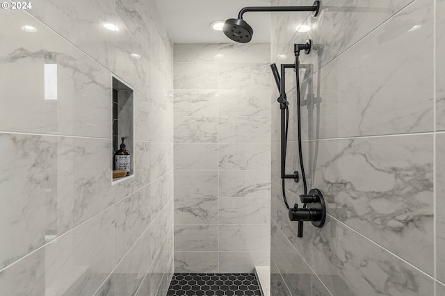 bathroom with a tile shower