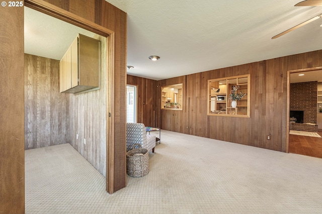 corridor with carpet and wood walls