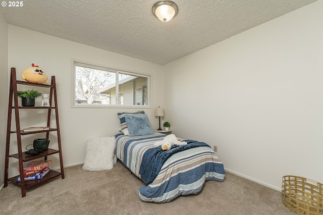 carpeted bedroom with baseboards and a textured ceiling