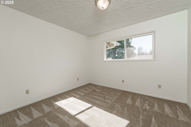 unfurnished room with baseboards, carpet, and a textured ceiling