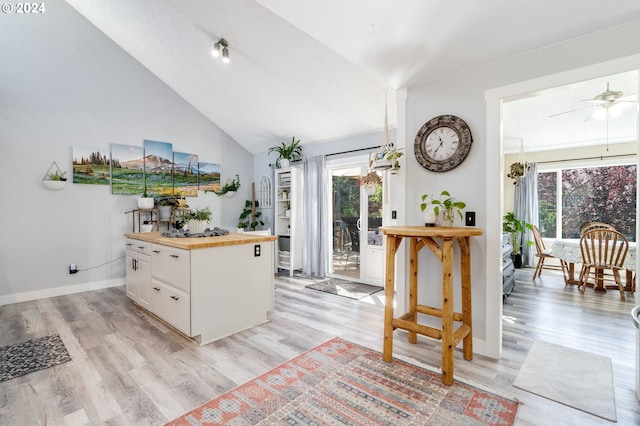 kitchen with white cabinets, butcher block countertops, ceiling fan, and light hardwood / wood-style flooring