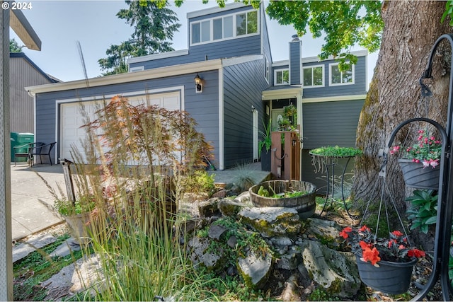 rear view of house with a garage