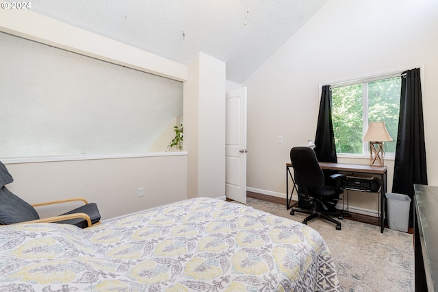 bedroom featuring a textured ceiling and vaulted ceiling